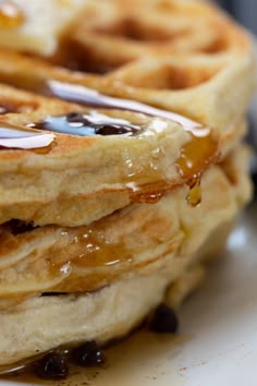 a stack of waffles with syrup drizzled on top