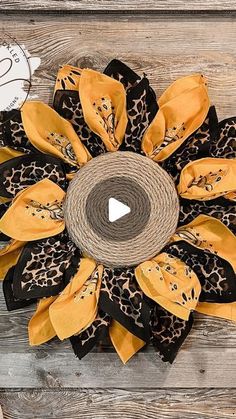 a large yellow and black flower on top of a wooden table