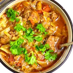 a bowl filled with meat and vegetables on top of a table