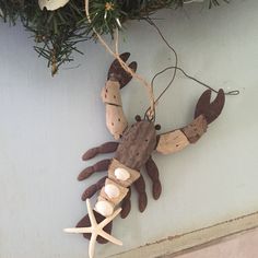 a wooden crab ornament hanging on a wall next to a starfish decoration