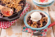 a bowl filled with fruit and ice cream on top of a table next to other bowls