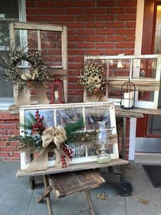 an old window is decorated with wreaths and other decorations for the front door to be displayed