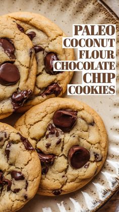 three chocolate chip cookies on a plate with the words paleo coconut flour chocolate chip cookies