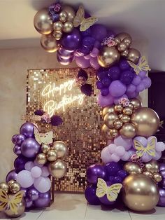 purple and gold balloons are arranged in the shape of a birthday arch with butterflies on it