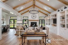 a living room filled with furniture and a large clock mounted to the side of the wall