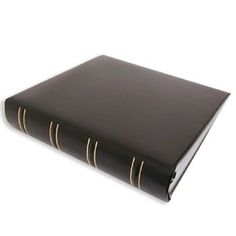 a black book with gold lines on the front and back cover is open to reveal an empty page