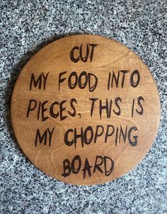 a wooden sign that says cut my food into pieces, this is my chopping board