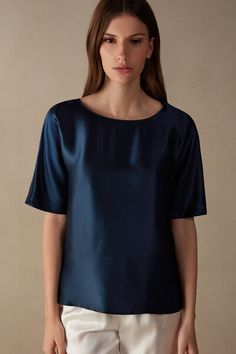 Kimono cut top with short, elbow-length sleeves and rounded boat neckline. The front is in pure silk satin and the back is in soft modal. Side vents. Loose fit.
The model is 5’ 9” (175 cm) tall and is wearing a size 2 / S.

The silk in this piece is bluesign® certified. Elegant Blue Half Sleeve Top, Elegant Silk Crew Neck Top, Elegant Short Sleeve Silk Top, Elegant Short Sleeve Satin Top, Elegant Satin Short Sleeve Top, Elegant Satin Tops With Short Sleeves, Blue Short Sleeve Silk Top, Blue Silk Short Sleeve Top, Elegant Short Sleeve Viscose Tops