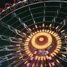 the ferris wheel is lit up at night