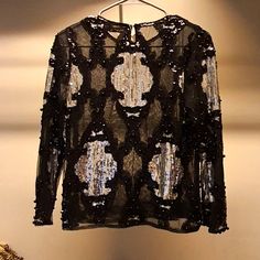 Beautiful Shear Long Sleeve Top With Silver Detailing. Elegant Sequined Tops For Winter, Elegant Winter Tops With Sequins, Elegant Sequined Winter Tops, Elegant Winter Sequin Tops, Metallic Embellished Tops For Party, Silver Embellished Party Top, Party Metallic Embellished Tops, Chic Silver Sequined Tops, Elegant Festive Winter Tops