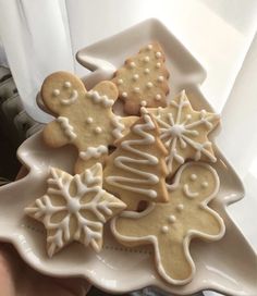 a white plate topped with lots of cut out cookies