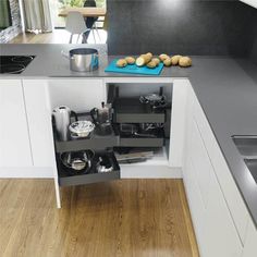 an open cabinet in the middle of a kitchen