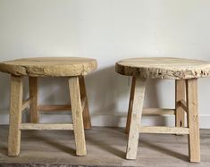 two wooden stools sitting next to each other