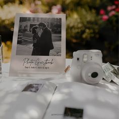 an old photo is sitting on a table next to a polaroid camera and other items