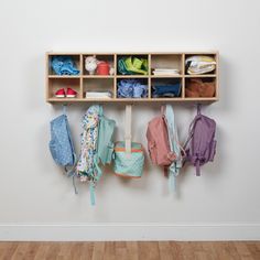 a wooden shelf filled with umbrellas and other items next to a wall mounted coat rack