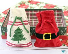 two crocheted christmas bags sitting next to each other