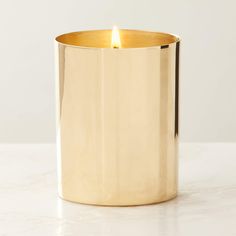 a gold candle holder on a white table