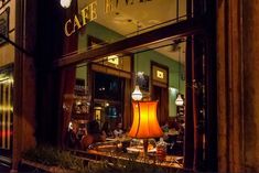 a lamp is sitting in the window of a restaurant