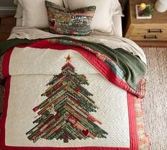 a christmas tree quilted on top of a bed