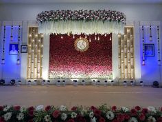 the stage is decorated with flowers and lights for a wedding or special occasion to be attended