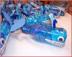 there are many blue water bottles in the shape of an airplane on top of each other