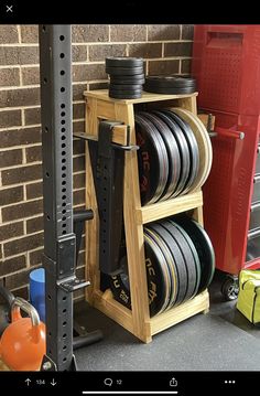 a rack filled with lots of plates next to a brick wall and storage bins