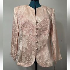 Add Some Sparkle To Your Wardrobe With This Stunning Pink Jacket From Nah Nah Collection. The Beaded, Sequined And Embroidered Detailing, Combined With Faux Pearls, Elevate This Jacket To A True Statement Piece. The Cotton And Acetate Outer Shell Material And Satin Fabric Type Make It Comfortable To Wear, While The Partially Lined And Shoulder Pad Features Ensure A Flattering Fit. This Jacket Has A Button Closure And Is 24 Inches In Length, With A Sleeve Length Of 23.5 Inches. It Is Perfect For Floral Embroidered Outerwear For Spring Evening, Spring Evening Outerwear With Floral Embroidery, Fitted Spring Outerwear For Mother Of The Bride, Spring Floral Embroidered Evening Outerwear, Elegant Embroidered Spring Outerwear, Elegant Embroidered Spring Blazer, Embroidered Fitted Outerwear For Evening, Embroidered Fitted Evening Outerwear, Fitted Embroidered Evening Outerwear