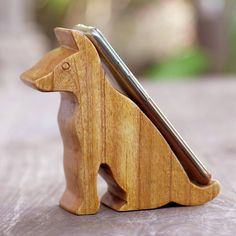 a wooden toy horse with a cell phone in it's back