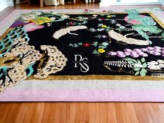 a black rug with colorful designs on it