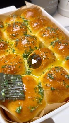 a casserole dish filled with cheese and broccoli being held by a spatula