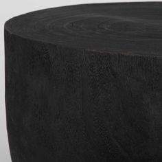 a close up of a wooden table with black wood graining on the top and bottom