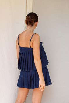 Color: Denim Pleated set Front bow top Button down shorts Model wears size small 74% Polyester 22% Viscose 4% Rayon Summer Ruffled Short Tops, Chic Short Blue Tops, Blue Short-length Top For Summer, Pleated Set, Bow Top, Short Models, Home Outfit, Skirt Pants, Dress Pants