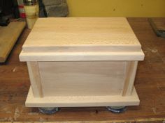 a small wooden cart sitting on top of a hard wood floor