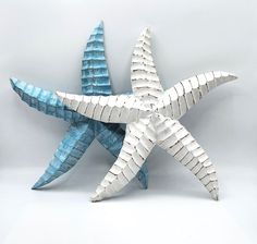 a white and blue starfish sculpture sitting on top of a table