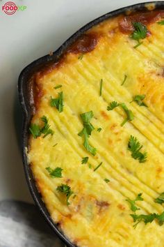 an omelet with parsley on top in a cast iron skillet, ready to be eaten