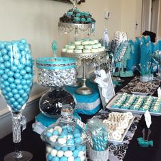 a table topped with lots of blue and white desserts