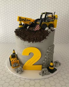 a construction themed birthday cake with the number two on it