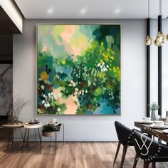 a large painting hanging on the wall in a dining room