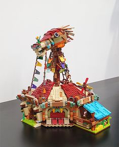 a building made out of legos sitting on top of a table