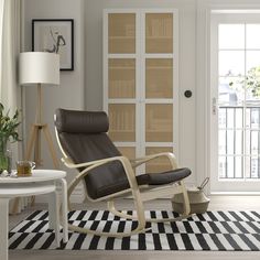 a living room with a rocking chair and rug