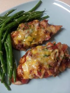 two pieces of chicken and green beans on a plate