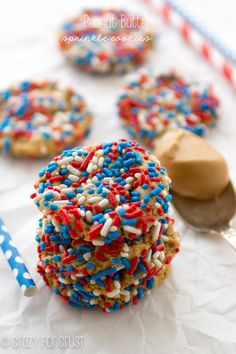 three cookies with red, white and blue sprinkles are stacked on top of each other