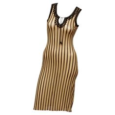 Jean Paul Gaultier Maille 90's Brown and Cream Stripe Sleeveless Dress in the iconic JPG stretch mesh. Black trim details along neckline and sleeve opening. Front neckline has a string and bead tie closure. Made in Italy Size; Medium , Measurements ; Shoulder 12' ; Bust 26" ; Waist 22" ; Hip 27" ; Shoulder to hem 40.4" ; Hem Opening 37" Dresses 90s, Striped Outfit, Met Gala Dresses, Tie Sleeve Dress, Fur Dress, Stripe Outfits, Striped Sleeveless Dress, Press Tour, Gala Dresses