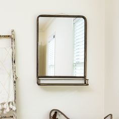 a bathroom with a sink, mirror and towel rack