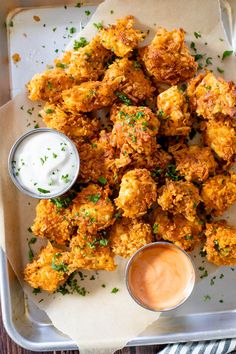 fried food on a tray with dipping sauce