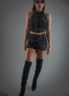 Sparkling two-piece set is the ultimate rave or festival outfit. The sparkling sequin top pairs perfectly with the matching high-waisted shorts, both designed to move with you as you dance the night away. The shimmery fabric catches the light, making you the star of the show. It's fun, flirty, and perfect for those high-energy nights. Just add some bold accessories and glitter, and you're ready to shine under the festival lights! Sequin Shorts For Night Out And Party Season, Fitted Sequin Shorts For Night Out, Disco Style Shorts For Night Out, Glamorous Fitted Shorts For Night Out, Glamorous Fitted Shorts For Party Season, Fitted Short Crop Top For Night Out, Fitted Short Length Crop Top For Night Out, Fitted Short-length Crop Top For Night Out, Black Rave Party Bottoms