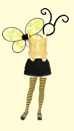 a woman in yellow shirt and black skirt with butterfly wings on her head, wearing striped tights