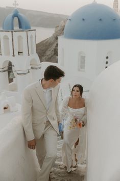 Husband and wife walking through the streets in santorini Greece after their intimate elopement Greece Micro Wedding, Wedding In Santorini, Santorini Greece Elopement, Greece Wedding Aesthetic, Elope Photos, Honey Moon Places