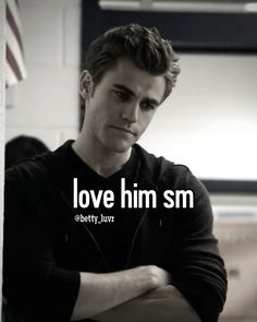 a man sitting down with his arms crossed and the words love him sm on it