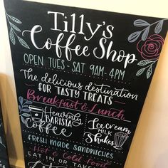 a chalkboard sign advertising coffee shops on the side of a wall in a cafe